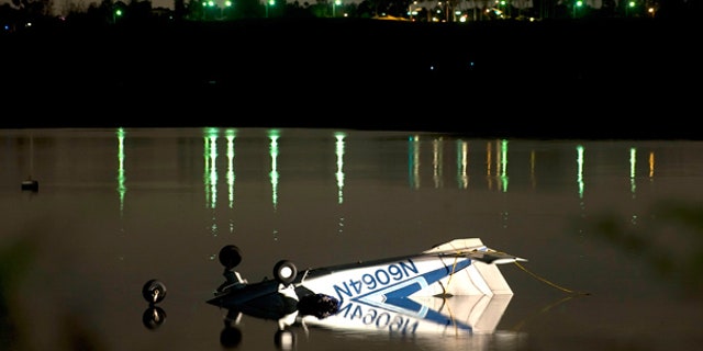 Nov. 21: Single engine plane rests in the shallow waters of Upper Newport Bay in Newport Beach, Calif.