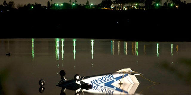 Nov. 21: Single engine plane rests in the shallow waters of Upper Newport Bay in Newport Beach, Calif.