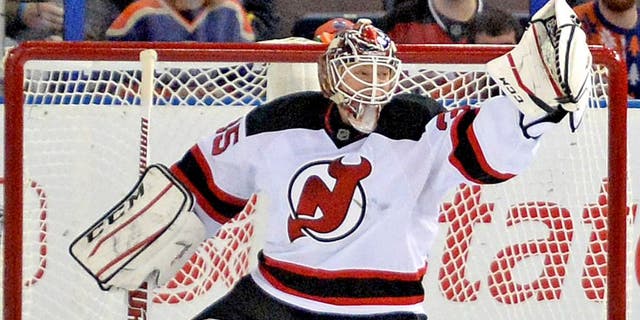Nov 21, 2014; Edmonton, Alberta, CAN; New Jersey Devils goalie Cory Schneider (35) makes a glove save against the Edmonton Oilers in the second period at Rexall Place. Mandatory Credit: Chris LaFrance-USA TODAY Sports