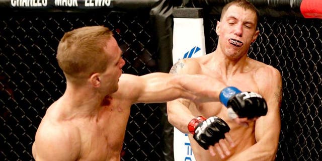 AUSTIN, TX - NOVEMBER 22: (L-R) Nick Hein of Germany punches James Vick in their lightweight bout during the UFC Fight Night event at The Frank Erwin Center on November 22, 2014 in Austin, Texas. (Photo by Josh Hedges/Zuffa LLC/Zuffa LLC via Getty Images)