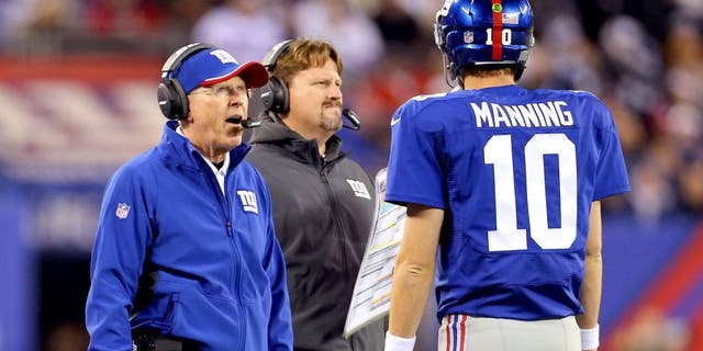 Nov 23, 2014; East Rutherford, NJ, USA; New York Giants head coach Tom Coughlin and offensive coordinator Ben McAdoo talk with quarterback Eli Manning (10) during a break in play against the Dallas Cowboys during the second quarter at MetLife Stadium. Mandatory Credit: Adam Hunger-USA TODAY Sports