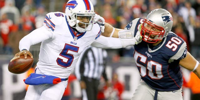 Nov 23, 2015; Foxborough, MA, USA; Buffalo Bills quarterback Tyrod Taylor (5) tries to break free from New England Patriots defensive end Rob Ninkovich (50) during the second half at Gillette Stadium. Mandatory Credit: Winslow Townson-USA TODAY Sports