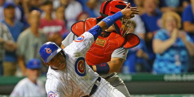Sep 25, 2016; Chicago, IL, USA; Chicago Cubs shortstop Addison Russell (27) is tagged out at home by St. Louis Cardinals catcher Yadier Molina (4) during the eighth inning at Wrigley Field. Mandatory Credit: Dennis Wierzbicki-USA TODAY Sports