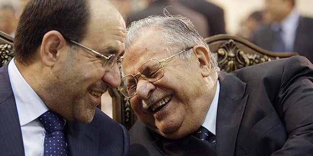 In this June. 27, 2009 file photo, Iraq's Prime Minister Nouri al-Maliki, left, and President Jalal Talabani, right, react, at a ceremony marking the 2003 death of Mohammed Baqir al-Hakim in Baghdad, Iraq.