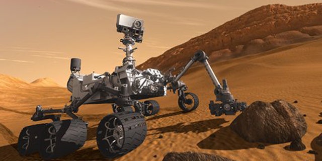 In this 2011 artist's rendering provided by NASA/JPL-Caltech, the Mars Science Laboratory Curiosity rover examines a rock on Mars with a set of tools at the end of its arm, which extends about 7 feet.