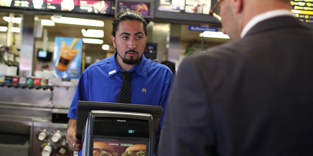 SAN FRANCISCO, CA - APRIL 19: McDonald's employee Salvador Ibarra takes an order during a one-day hiring event at a McDonald's restaurant on April 19, 2011 in San Francisco, California. Hundreds of job seekers filled out applications and were interviewed at a San Francisco McDonald's restaurant during a one-day nationwide event at the chain as they look to fill 50,000 positions at stores nationwide. (Photo by Justin Sullivan/Getty Images)