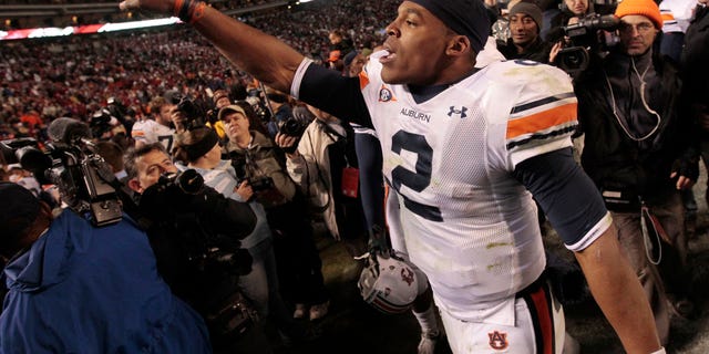 Nov. 26: Auburn quarterback Cameron Newton celebrates after their 28-27 win over Alabama in an NCAA college football game at Bryant-Denny Stadium in Tuscaloosa, Ala.