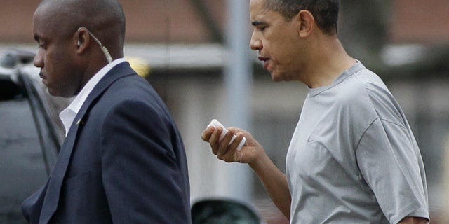 Nov. 26: President Obama walks with a U.S. Secret Service agent back to his vehicle after playing a private game of basketball at Fort McNair in Washington.