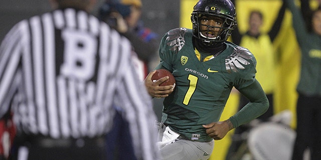 nov. 26: Oregon quarterback Darron Thomas (1) looks up after scoring a touch down in the third quarter during an NCAA college football game against Arizona in Eugene, Ore.