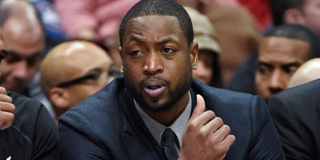 Nov 14, 2014; Atlanta, GA, USA; Miami Heat guard Dwyane Wade (3) shown on the bench in street clothes during the game against the Atlanta Hawks during the second half at Philips Arena. The Hawks defeated the Heat 114-103. Mandatory Credit: Dale Zanine-USA TODAY Sports