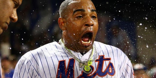 Aug 29, 2016; New York City, NY, USA; New York Mets left fielder Yoenis Cespedes (52) reacts after being doused by Mets second baseman Wilmer Flores (not pictured) during his post game interview after hitting a walk off solo home run against the Miami Marlins during the tenth inning at Citi Field. Mandatory Credit: Brad Penner-USA TODAY Sports