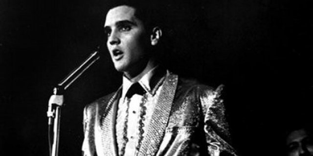 In this photo taken March 25, 1961 and provided by the World War II Valor in the Pacific National Monument, Elvis Presley performs at the Bloch Arena on the Pearl Harbor Navel base in Honolulu, Hawaii. Fifty years ago, Elvis Presley helped raise money and bring attention to help build the USS Arizona Memorial. The King is being asked to deliver one more time.  (AP Photo/ Word War II Valor in the Pacific National Monument)