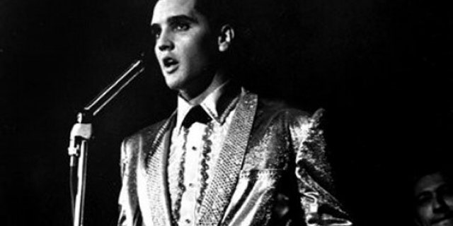 In this photo taken March 25, 1961 and provided by the World War II Valor in the Pacific National Monument, Elvis Presley performs at the Bloch Arena on the Pearl Harbor Navel base in Honolulu, Hawaii. Fifty years ago, Elvis Presley helped raise money and bring attention to help build the USS Arizona Memorial. The King is being asked to deliver one more time. (AP Photo/ Word War II Valor in the Pacific National Monument)