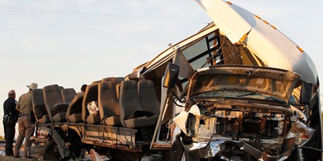 November 4, 2011: Investigators examine a bus after the crash Paint Rock, Texas.