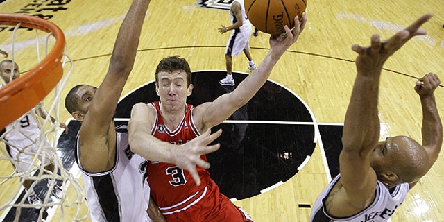 Nov. 17: Chicago Bulls' Omer Asik (3), of Turkey, goes to the basket between San Antonio Spurs' Tim Duncan, left, and Richard Jefferson during the second quarter of an NBA basketball game in San Antonio.