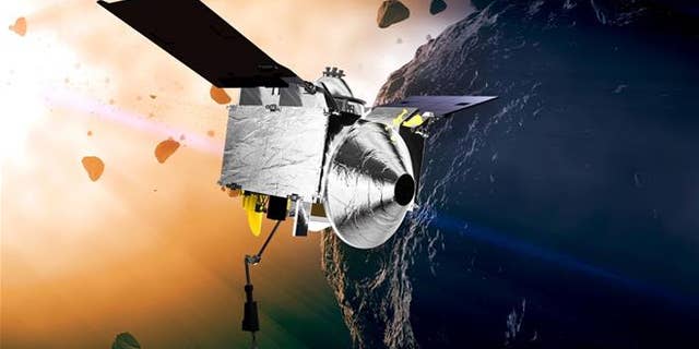 This illustration provided by NASA depicts the OSIRIS-REx spacecraft at the asteroid Bennu.