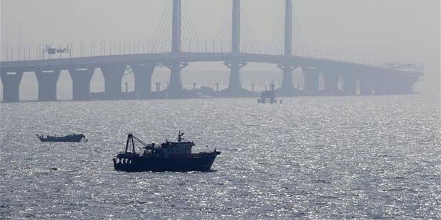 A boat sails near the Hong Kong-Zhuhai-Macau Bridge, in Zhuhai city in China on March 28, 2018.