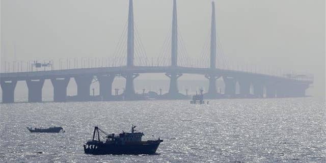 A boat sails near the Hong Kong-Zhuhai-Macau Bridge, in Zhuhai city in China on March 28, 2018.