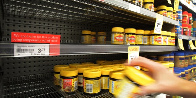 March 20, 2012: A customer takes a jar of Vegemite from next to an empty shelve where Marmite should be stocked in a supermarket in Auckland, New Zealand.