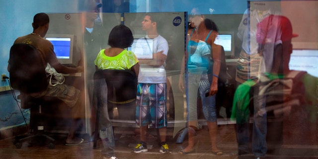 People line up at a post office as they wait to use the Internet service in Havana, Cuba, Tuesday, May 28, 2013.