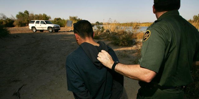 YUMA, AZ - MARCH 17:  U.S. Customs and Border Protection border patrol agent Ben Vik apprehends a suspected illegal immigrant on the California side of the Colorado River on March 17, 2006 near Yuma, Arizona. As Congress begins a new battle over immigration policy, U.S. Customs and Border Protection (CBP) border patrol agents in Arizona are struggling to control undocumented immigrants that were pushed into the region by the 1990?s border crack-down in California called Operation Gatekeeper. A recent study by the Pew Hispanic Center using Census Bureau data estimates that the United States currently has an illegal immigrant population of 11.5 million to 12 million, about one-third of them arriving within the past 10 years. More than half are from Mexico. Ironically, beefed-up border patrols and increased security are reportedly having the unintended result of deterring many from returning to their country of origin.  (Photo by David McNew/Getty Images)