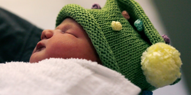 Dec. 12, 2012: Newborn Noelle Joy Klinker, of Reading, Mass., who was born at 12:12 p.m. at the Massachusetts General Hospital, rests in her mother Colleen's arms a few hours after birth.