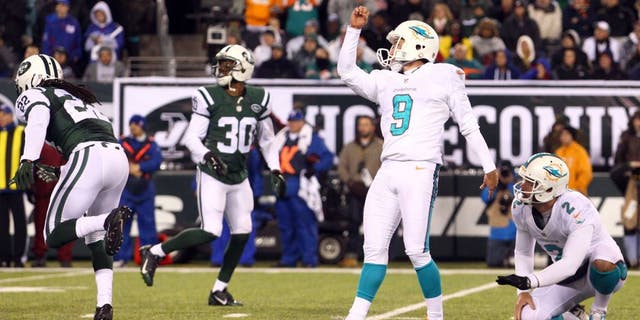 Dec 1, 2014; East Rutherford, NJ, USA; Miami Dolphins kicker Caleb Sturgis (9) kicks a field goal against the New York Jets during the fourth quarter of a game at MetLife Stadium. The Dolphins defeated the Jets 16-13. Mandatory Credit: Brad Penner-USA TODAY Sports