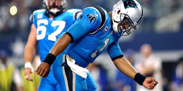 ARLINGTON, TX - NOVEMBER 26: Cam Newton #1 of the Carolina Panthers celebrates after scoring a touchdown against the Dallas Cowboys as teammate Ryan Kalil #67 looks on in the second half at AT&T Stadium on November 26, 2015 in Arlington, Texas. (Photo by Ronald Martinez/Getty Images)