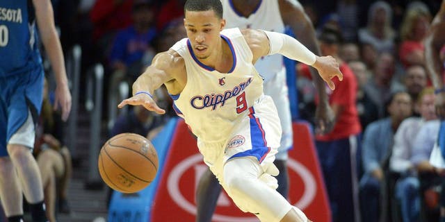 Dec 1, 2014; Los Angeles, CA, USA; Los Angeles Clippers guard Jared Cunningham (9) reaches for the ball against the Minnesota Timberwolves at Staples Center. The Clippers defeated the Timberwolves 127-101. Mandatory Credit: Kirby Lee-USA TODAY Sports