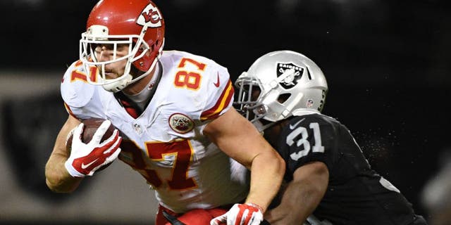 November 20, 2014; Oakland, CA, USA; Kansas City Chiefs tight end Travis Kelce (87) is tackled by Oakland Raiders defensive back Neiko Thorpe (31) during the third quarter at O.co Coliseum. The Raiders defeated the Chiefs 24-20. Mandatory Credit: Kyle Terada-USA TODAY Sports