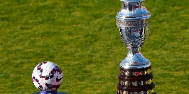 View of the Copa America trophy (R) and the football before the start of the 2015 Copa America football championship final Argentina vs Chile, in Santiago, Chile, on July 4, 2015. AFP PHOTO / MARTIN BERNETTI (Photo credit should read MARTIN BERNETTI/AFP/Getty Images)