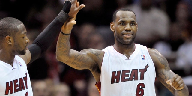 Dec. 2: Miami Heat guard Dwyane Wade (3) high-fives teammate LeBron James in the third quarter of an NBA basketball game against the Cleveland Cavaliers in Cleveland.