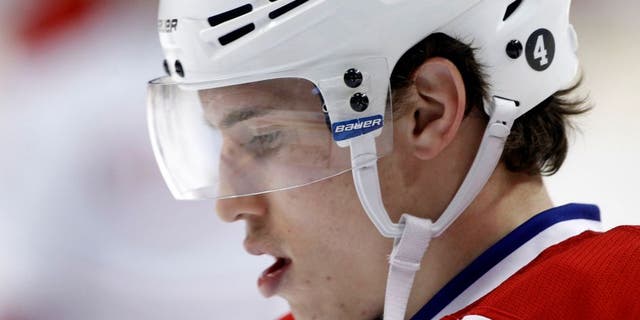 Montreal Canadiens right wing Brendan Gallagher wears a number 4 decal on his helmet in honor of hockey legend Jean Beliveau during warmups before an NHL hockey game against the Minnesota Wild in St. Paul, Minn., Wednesday, Dec. 3, 2014. (AP Photo/Ann Heisenfelt)