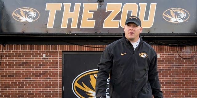 FILE - In this Saturday, Nov. 21, 2015 file photo, Missouri defensive coordinator Barry Odom walks on the field before the start of their NCAA college football game against Tennessee in Columbia, Mo. Missouri has promoted defensive coordinator Barry Odom to replace the retiring Gary Pinkel as head coach. The school said in a release Thursday night, Dec. 3, 2015 that Odom had agreed in principle to a five-year deal that will need to be approved by the schoolâs board of curators next week.(AP Photo/L.G. Patterson, File)