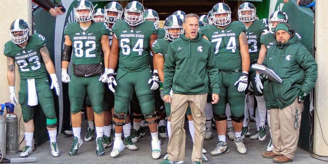 Nov 28, 2015; East Lansing, MI, USA; Michigan State Spartans head coach Mark Dantonio leads his team onto the field prior to a game against the Penn State Nittany Lions at Spartan Stadium. Mandatory Credit: Mike Carter-USA TODAY Sports