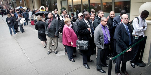 Job seekers wait in line to see employers at a National Career Fairs' job fair in New York.