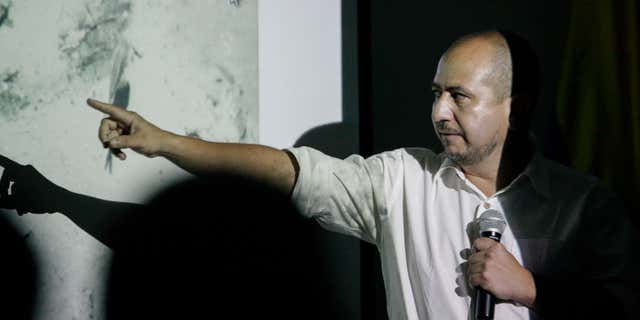 Dec. 5, 2015: Ernesto Montenegro, Director of the Colombian Institute of Anthropology and History of Colombia, talks to the media while he shows a picture of remains of the Galleon San Jose during a press conference in Cartagena, Colombia,