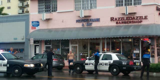 Dec. 5, 2015: In this photo provided by Marcellus Johnson, authorities draw their guns on a man suspected in a bank robbery in Miami Beach, Fla.