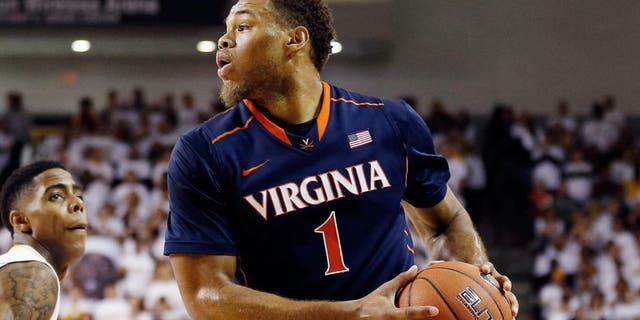 Dec 6, 2014; Richmond, VA, USA; Virginia Cavaliers guard Justin Anderson (1) looks to pass the ball as Virginia Commonwealth Rams guard/forward Terry Larrier (22) defends in the second half at Stuart Siegel Center. The Cavaliers won 74-57. Mandatory Credit: Geoff Burke-USA TODAY Sports