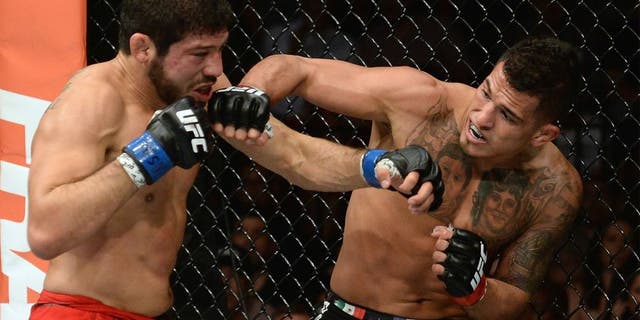 LAS VEGAS, NV - DECEMBER 06: (R-L) Anthony Pettis punches Gilbert Melendez in their UFC lightweight championship bout during the UFC 181 event inside the Mandalay Bay Events Center on December 6, 2014 in Las Vegas, Nevada. (Photo by Robert Laberge/Zuffa LLC/Zuffa LLC via Getty Images)