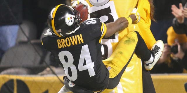 Dec 6, 2015; Pittsburgh, PA, USA; Pittsburgh Steelers wide receiver Antonio Brown (84) jumps onto the goal post padding after scoring on a seventy-one yard punt return for a touchdown against the Indianapolis Colts during the fourth quarter at Heinz Field. The Steelers won 45-10. Mandatory Credit: Charles LeClaire-USA TODAY Sports