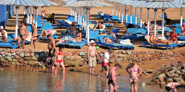 Dec. 6: Tourists sunbathe and stand in the shallow waters at the Egyptian Red Sea resort of Sharm el-Sheikh, Egypt.