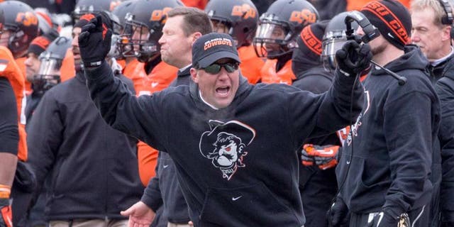 Dec 7, 2013; Stillwater, OK, USA; Oklahoma State Cowboys head coach Mike Gundy reacts to a call during the third quarter against the Oklahoma Sooners at Boone Pickens Stadium. Mandatory Credit: Richard Rowe-USA TODAY Sports