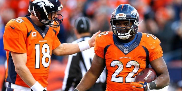Denver Broncos running back C.J. Anderson, right, celebrates his touchdown with quarterback Peyton Manning during the second half in an NFL football game Sunday, Dec. 7, 2014, in Denver. (AP Photo/David Zalubowski)