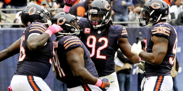 Oct 4, 2015; Chicago, IL, USA; Chicago Bears nose tackle Eddie Goldman (91) celebrates with Chicago Bears defensive end Jarvis Jenkins (96), Chicago Bears outside linebacker Pernell McPhee (92) and Chicago Bears linebacker Lamarr Houston (99) after he sacked Oakland Raiders quarterback Derek Carr (4) in the first half at Soldier Field. Mandatory Credit: Matt Marton-USA TODAY Sports
