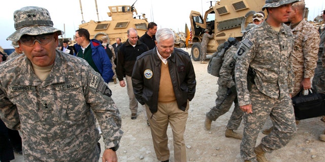 Dec. 7: Defense Secretary Robert Gates walks with Maj. Gen. John Campbell, left,, commanding general of the 101st Air Assault, in Kunar Province, Afghanistan in Afghanistan.