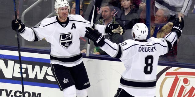 Los Angeles Kings' Jeff Carter, left, celebrates his goal against the Columbus Blue Jackets with teammate Drew Doughty during the third period of an NHL hockey game in Columbus, Ohio, Tuesday, Dec. 8, 2015. Los Angeles won 3-2 in overtime. (AP Photo/Paul Vernon)