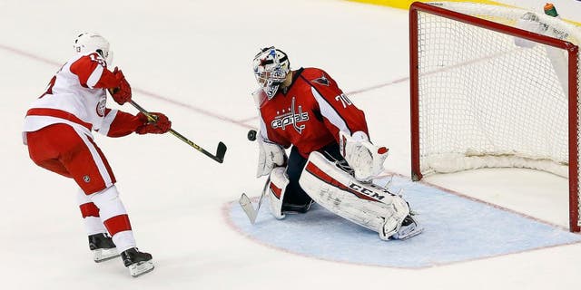 Dec 8, 2015; Washington, DC, USA; Washington Capitals goalie Braden Holtby (70) makes the game clinching save against Detroit Red Wings center Pavel Datsyuk (13) in a shootout at Verizon Center. The Capitals won 3-2 in a shootout. Mandatory Credit: Geoff Burke-USA TODAY Sports
