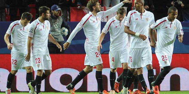 Sevilla's Spanish forward Fernando Llorente (C) celebrates with teammates after scoring a goal during the UEFA Champions League Group D football match Sevilla FC vs Juventus at the Ramon Sanchez Pizjuan stadium in Sevilla on December 8, 2015. AFP PHOTO/ CRISTINA QUICLER / AFP / CRISTINA QUICLER (Photo credit should read CRISTINA QUICLER/AFP/Getty Images)