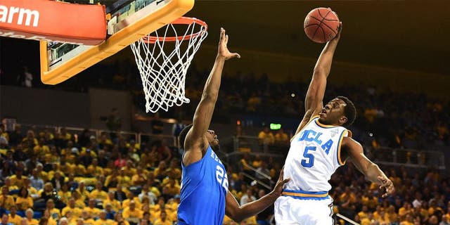 LOS ANGELES, CA - DECEMBER 03: Prince Ali #5 of the UCLA Bruins dunks over Alex Poythress #22 of the Kentucky Wildcats during an 87-77 UCLA win at Pauley Pavilion on December 3, 2015 in Los Angeles, California. (Photo by Harry How/Getty Images)